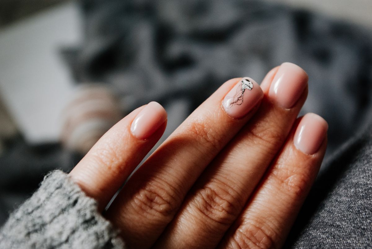 Extra short natural nails with nude polish and minimal nail art